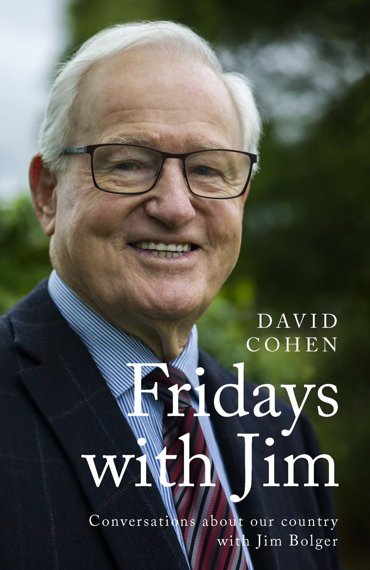 Book cover of 'Fridays with Jim' by David Cohen featuring a smiling Jim Bolger wearing glasses and a suit.